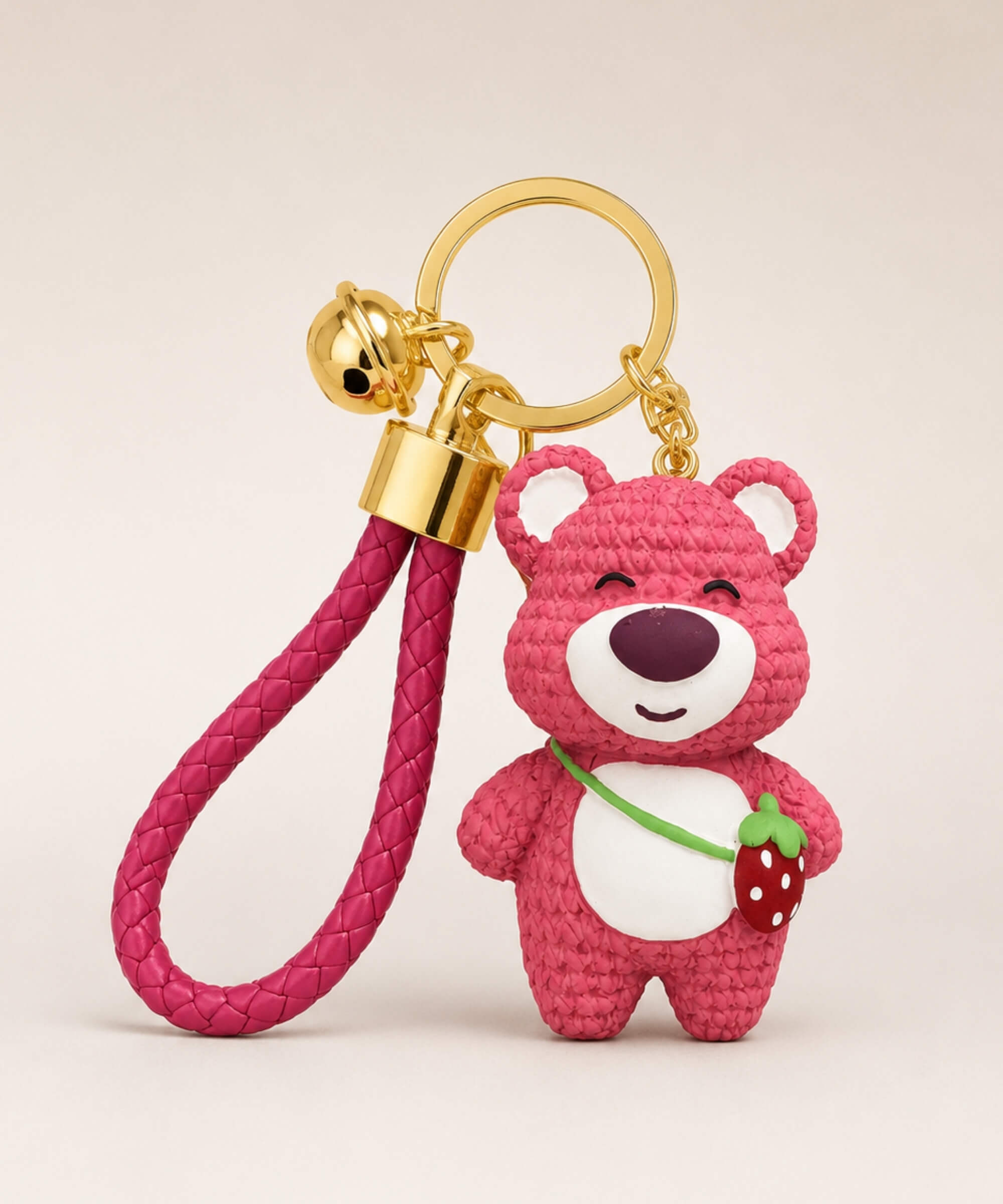 Rose pink strawberry bear resin keychain with strawberry detail, braided wrist strap and gold hardware